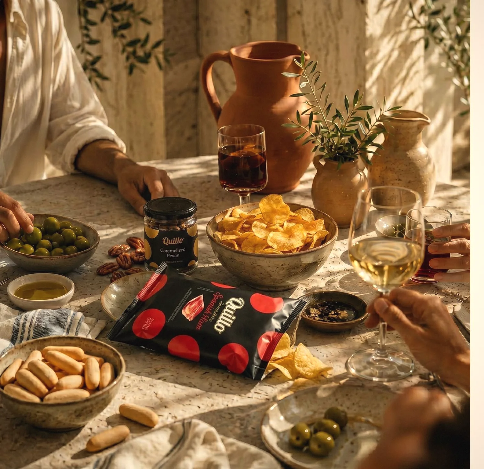 A Spanish table set for aperitivo with QUILLO chips and Marcona almonds